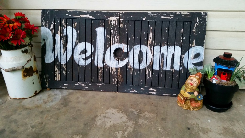 fairy garden sitting to the right of a welcome sign