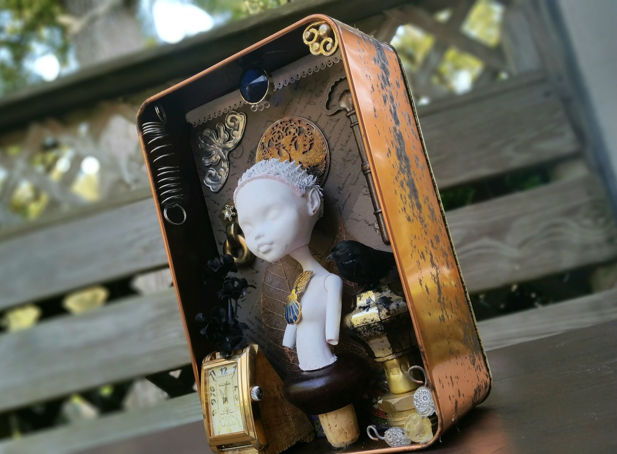finished assemblage piece, a bust of a doll with a semi-steampunk aesthetic